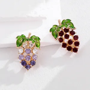 Exquisite grape brooch close-up, featuring sparkling rhinestones and green enamel leaf design.