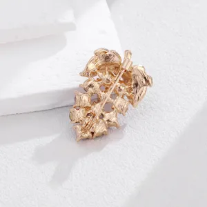Detail view of the gold-toned grape brooch back featuring a secure safety pin clasp mechanism.