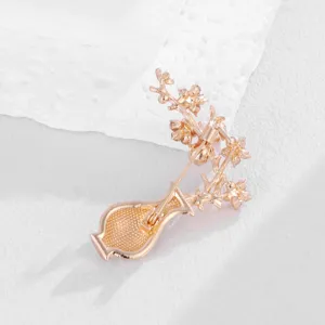 Detailed view of the elegant rose gold tone vase plum blossom brooch pin mechanism back.