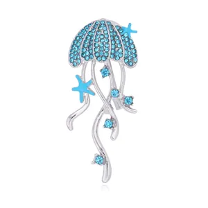 Detailed view of the sparkling rhinestone jellyfish brooch with blue starfish and crystal accents.
