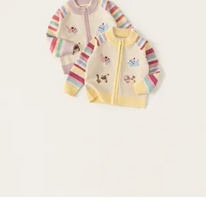 Kids knitted cardigan detail featuring cute embroidered cat patterns and colorful striped sleeves.