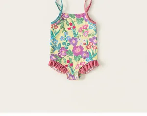 Girls floral one-piece swimsuit, cute yellow botanical print with ruffles and straps.