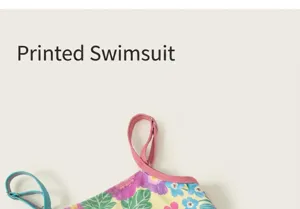 Close-up detail shot of girls floral print one-piece swimsuit with adjustable straps.