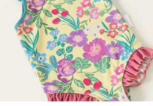Detailed view of kids floral one-piece swimsuit, vibrant yellow print with ruffles.