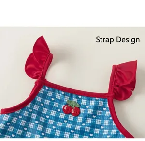 Girls blue plaid one-piece swimsuit with red ruffle straps and cute cherry embroidery detail.