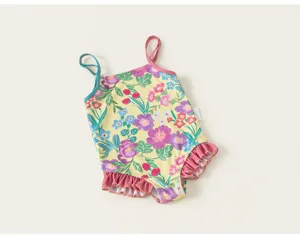 Girls one-piece floral swimsuit with colorful botanical print and cute ruffled hem details.