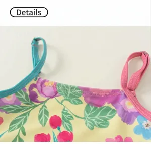 Close-up detail of girls floral print swimsuit strap and colorful botanical fabric pattern.