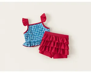 Girl's cute blue plaid and red ruffles two-piece swimsuit detail view, showing delicate design.