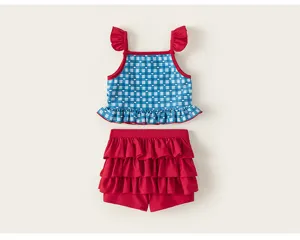 Close-up details of girls blue checkered swimsuit with red ruffles and cute heart prints.