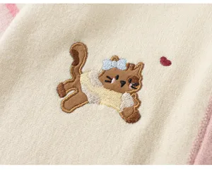 Exquisite embroidery detail of cute cat on knitwear, soft texture, cozy toddler cardigan.