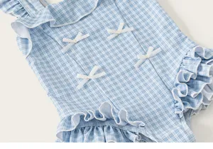 Girl one-piece swimsuit detail shot, blue gingham pattern, sweet ruffles and cute bows.