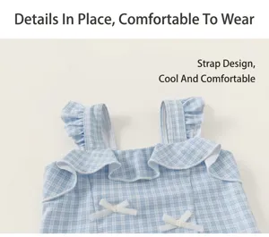 Detailed view of girls blue plaid one-piece swimsuit with cute ruffles and bows.