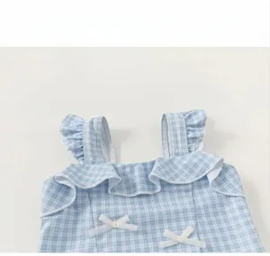 Girl one-piece swimsuit detail shot, blue white plaid, ruffles and bows, summer kids swimwear.