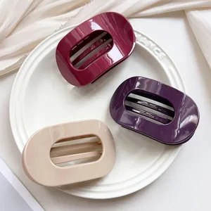 Oval hair claw clips set in maroon, purple and beige. Elegant shark clips for styling hair.