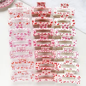 Detailed view of sweet pink and white bow cherry hair claw clips, cute square shark hair clips.