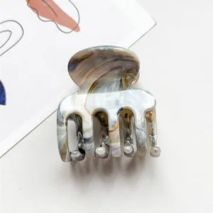 Nahaufnahme Detail der kleinen vierzahnigen marmorierten Haarklammer, elegantes Design.