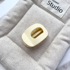 Detail shot of the matte light yellow hollow oval hair claw clip, perfect for daily styling.