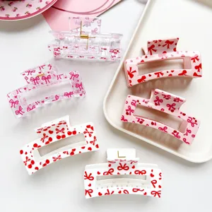 Detail view of sweet pink bow square hair claw clips, cute cherry print shark clips for women.