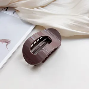 Elegant brown oval hair claw clip minimalist hair accessory for daily styling and elegant buns.