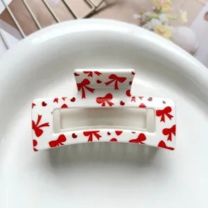 Sweet square hair claw clip featuring a cute red bow and heart print for women and girls.