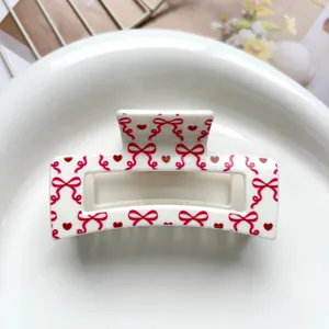 Sweet white square hair claw clip featuring cute red bow and heart print for women and girls.