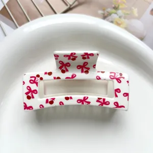 Detail view of pink bow cherry print square hair claw clip, sweet style, premium resin accessory.