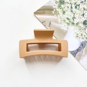 Minimalist matte rectangular hair claw clip in elegant apricot, perfect for daily elegant styles.