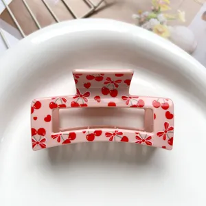 Pink square hair claw clip featuring sweet red cherry and cute bow design for women daily wear.