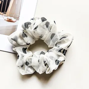 Detailed shot of sweet chiffon rhinestone hair scrunchie with cute heart pattern for daily wear.