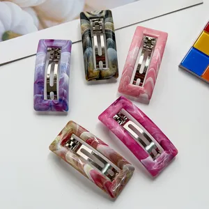 Marble resin spring hair clip detail shot, featuring rectangular aesthetic and metal clasp.