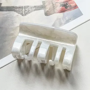 White marble hair claw clip detail shot, elegant resin hair accessory for women styling.