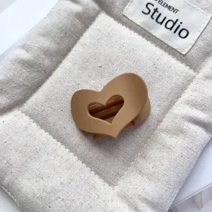 Matte brown hollow heart hair claw detail, compact size for half-up hairstyles and daily wear.