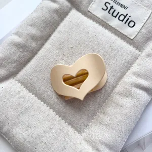 Detail view of a matte hollow heart hair claw clip, cute daily mini hair accessory for women.