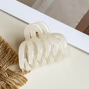 Milchweiße Kürbis Haarklammer, stilvolles hohles geschwungenes Design für schickes halboffenes Haar.