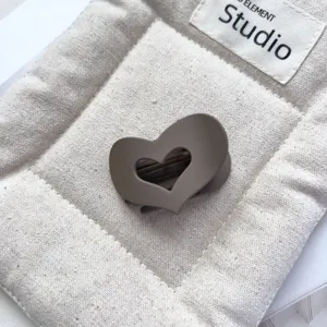 Detailed view of the matte brown heart-shaped hollow hair claw clip for elegant half-up hairstyles.