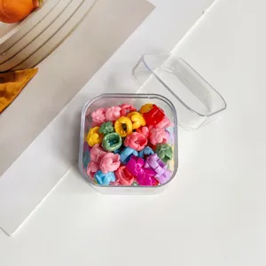 Mini pinces à cheveux en forme de fleur colorée dans une boîte transparente, accessoires.