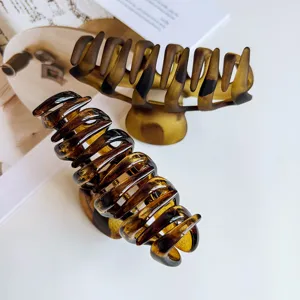 Large amber hair claw clip, glossy and matte acrylic shark clip for thick hair styling.