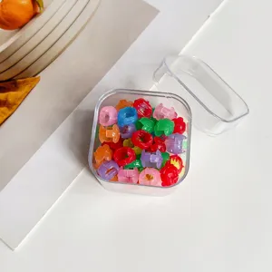 Vue détaillée de mini pinces à cheveux colorées bien rangées dans une boîte transparente.