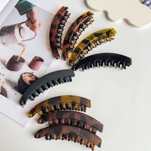 Tortoise shell and black banana hair clips for women, stylish ponytail claw clip details.
