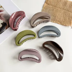Detailed view of minimalist crescent hair claw clips in various chic colors for daily hairstyles.