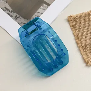 Blue transparent flat hair claw clip, hollow out oval geometric design for women detail view.