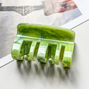 Green marble hair claw clip for women, stylish acrylic hair accessory for daily styling.
