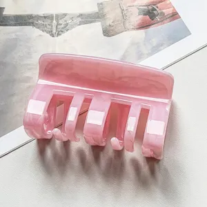 Pink marble hair claw clip detail close-up, stylish acetate hair accessory for daily use.