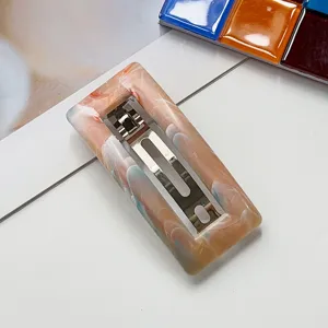 Marble texture rectangular hair barrette detail shot, elegant acrylic spring clip for women.