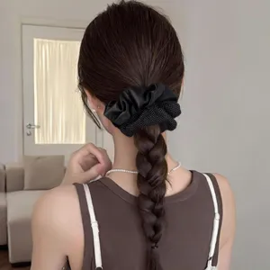 Elegant black satin and polka dot hair scrunchie, perfect stylish ponytail holder accessory.
