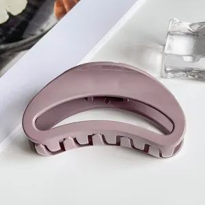 Close-up detail of a stylish purple geometric hair claw clip, perfect grip for daily use.