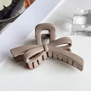 Elegant bow hair claw clip detail, premium large resin shark clip for stylish hairstyles.