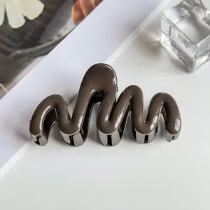 Glossy dark brown wavy hair claw clip detail, stylish and elegant hair accessory for styling.
