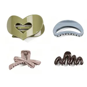 Set of 4 stylish hair claw clips featuring heart, bow, and wavy designs for women and girls.