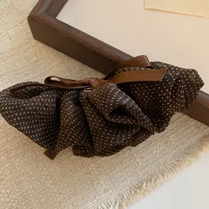 Brown polka dot hair scrunchie with bow detail retro gentle hair accessory detail shot